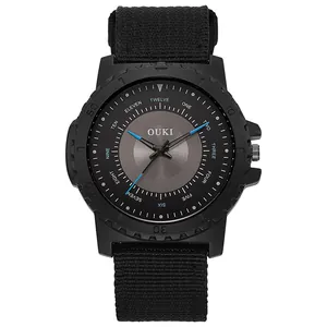 Detail of OUKI quartz watch featuring black nylon strap and unique English word hour markers