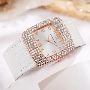 Square rose gold watch with rhinestone bezel and white crocodile leather strap