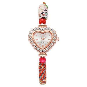 Detailed view of heart-shaped quartz watch with crystal bezel and braided strap