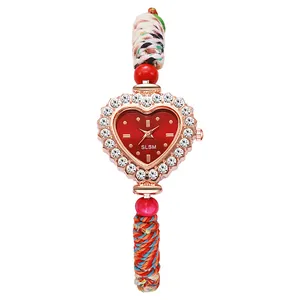 Detail of heart-shaped quartz watch with crystal bezel and ethnic braided beaded strap