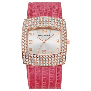 Detail view of square women watch with diamond bezel and pink crocodile leather strap