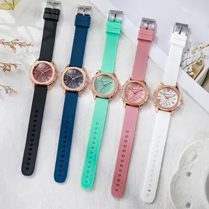 Five minimalist women's watches with silicone straps and rose gold cases in various colors