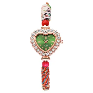Luxury heart-shaped quartz watch with emerald green dial and colorful woven strap