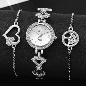 Macro shot of silver quartz watch with rhinestone bezel and matching charm bracelets