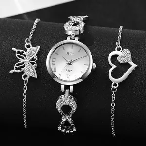 Detail of silver quartz watch set with infinity links, butterfly and heart bracelets