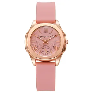 Close-up of octagonal rose gold case and pink dial with radial texture on a quartz watch