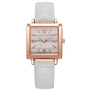 Detail of square rose gold watch with marble dial and white crocodile leather strap