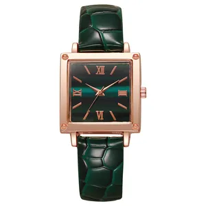 Detailed macro of a rose gold square watch featuring a gradient green dial and Roman numerals
