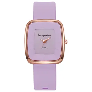Detailed macro view of the purple silicone strap and rose gold square quartz watch