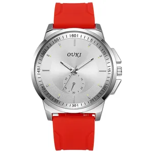 Close-up of OUKI quartz watch featuring a silver sunburst dial and red silicone strap