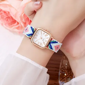 Vintage square quartz watch with a colorful woven strap and golden Roman numeral dial