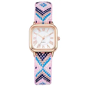 Detail of square rose gold watch with ethnic bohemian colorful woven fabric strap