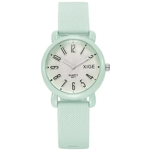 Close-up of mint green silicone watch strap with non-slip texture and white dial details