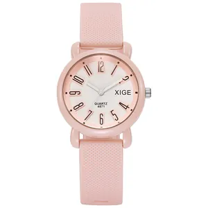 Close-up of pink silicone watch strap texture and clear white dial with Arabic numerals