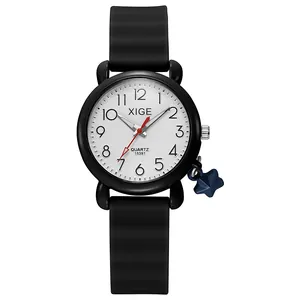 Detail of quartz watch featuring a white dial, red second hand, and blue star charm