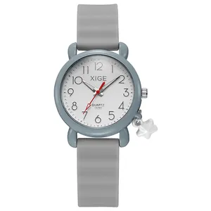 Close-up of gray quartz watch for students with star pendant and clear numeric dial