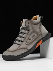 Detailed stitching and orange honeycomb design on high-top leather casual boots
