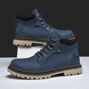 Detail of blue suede work boots with metal eyelets and thick non-slip rubber soles