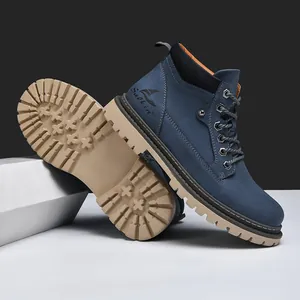Close-up of dark blue nubuck work boots featuring durable rubber soles and metal eyelets