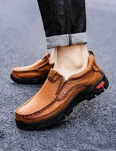 Detail of men's brown leather outdoor shoes with rugged stitching and durable rubber soles