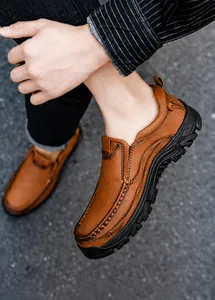 Detail of men's brown leather slip-on shoes with visible stitching and rubber soles