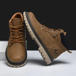 Detail of tan suede work boots featuring metal eyelets and durable rubber lug soles