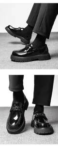 Detail of glossy black platform loafers featuring chunky treads and chain hardware