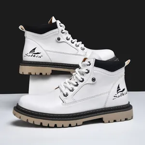 Detail of white high-top work boots with thick lug sole and brand logo on synthetic leather