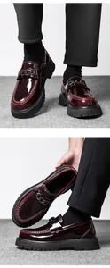 Close-up of burgundy patent leather loafers with metal chain and chunky platform sole