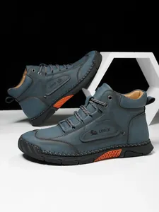 Detailed macro view of the LDECK men's leather work boot with stitching and rubber sole
