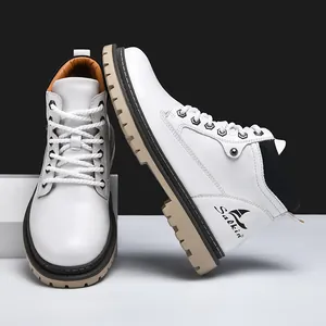 Detailed side view of white leather work boots with heavy duty khaki lug soles