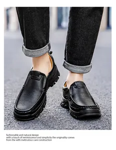 Close-up of black pebble leather slip-on shoes with thick rubber outsole on asphalt