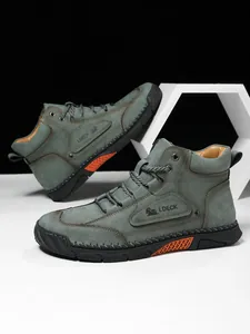 Detailed view of dark green leather boot showing artisan stitching and rubber sole accents
