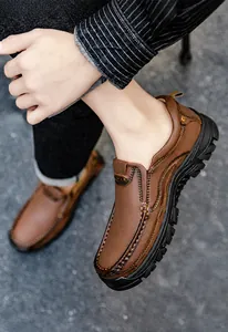 Outdoor shot of men's brown leather casual loafers featuring thick anti-slip soles and stitching