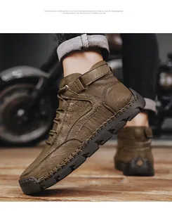 Detail of dark olive green leather men boot with handmade stitching and rubber outsole