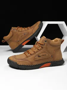 Detailed view of brown leather boots showing stitching, metal eyelets and LDECK logo