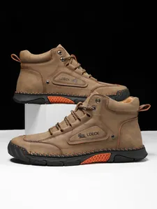 Detailed close-up of brown leather work boot with LDECK logo and contrast stitching
