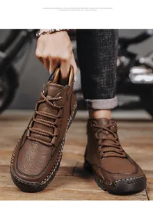 Detail of brown pebbled leather men boots with hand-stitched seams and rubber sole