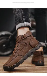 Detail of men's brown leather boots showing hand-stitched seams and non-slip rubber soles