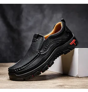 Detail of black leather outdoor shoe showing non-slip rubber sole and stitching