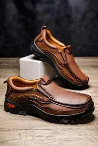 Detail of brown leather outdoor shoes with reinforced stitching and non-slip rubber soles