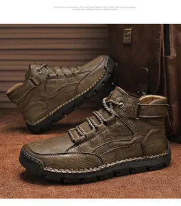 Detailed close-up of brown leather men's boots featuring bold stitching and rubber sole