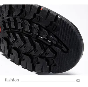 Detail of black rubber outsole with anti-slip grooves and red accents for hiking shoes