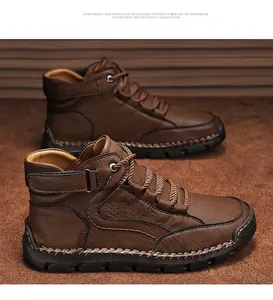 Macro view of brown leather boots showing thick stitching and rugged rubber sole