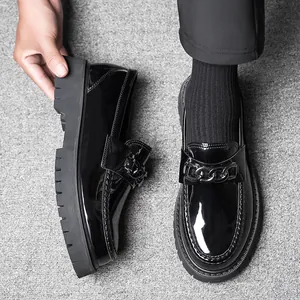 Men's black patent leather platform loafers with chunky chain link detail and thick sole
