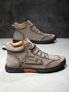 Detail view of khaki suede work boot with durable stitching and black rubber sole