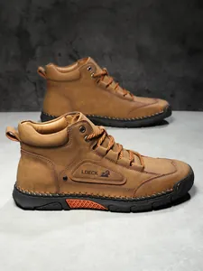 Detail of tan leather men's boot showing contrast stitching and durable thick rope laces