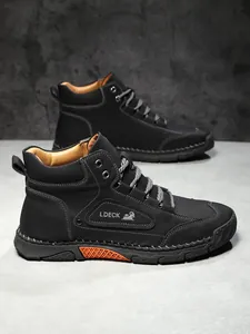 Close-up of black leather boots showing high-quality stitching and LDECK logo embroidery