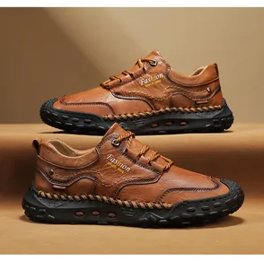 Macro view of hand-stitched seams and side printing on brown leather casual men shoes