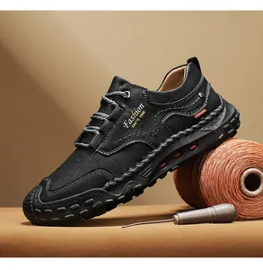 Detail of hand-stitched black leather loafers featuring Fashion SINCE 1996 side logo